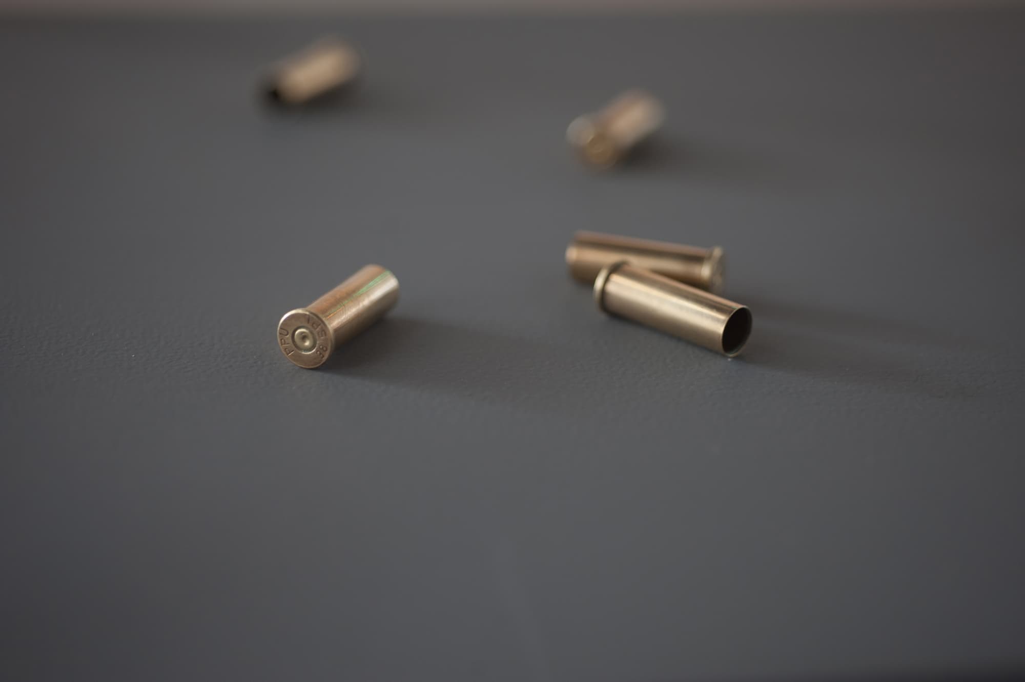 Six Shots Shots from the Capitol Steps (detail), Slide projection, amplified sound, six bullet shells, inverted pedestal, 68 in. x 18.75 in. x 18.75 in, 2012
